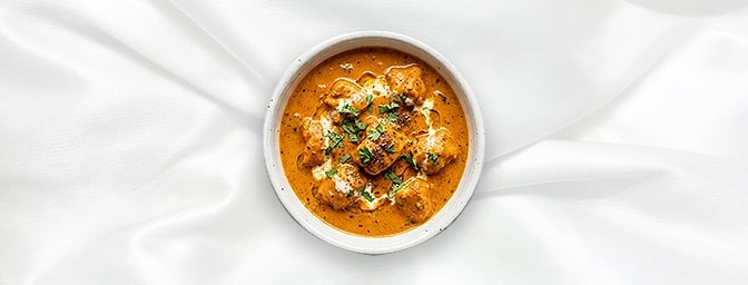 Butter Chicken - Taster — Indulge in a boutique portion of our legendary favorite. Succulent tandoor-grilled chicken cubes ar