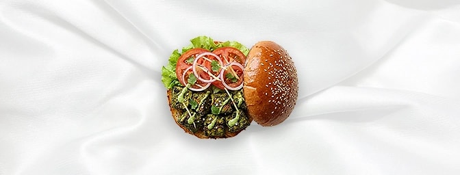 Chicken Tikka Cafreal Burger — Embark on a Goan adventure with succulent boneless chicken marinated in a vibrant fusion of fr