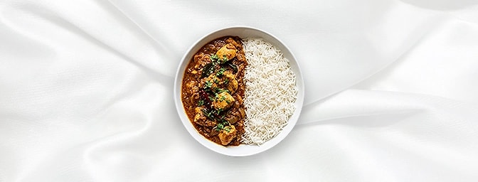 Chicken Madras Rice Bowl — Ignite your senses with this bold, full-sized combo. Fiery Madras chicken, rich with coconut milk,
