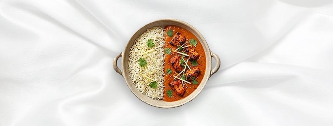 Chicken Tikka Masala Rice bowl — The perfect duo: half-section aromatic basmati rice and half-section of our iconic curry. Fe