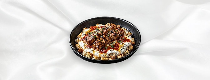 Chicken Iskender — Chargrilled Chicken On A Bed Of Diced Bread With Yoghurt And Topped With Anatolian Sauce And Melted Butter