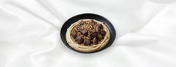 Humus Kavurma — Juicy Bits Of Pan Fried Lamb With Pine Kernels Served Over A Bed Of Humus, GB Canteen Hitchin