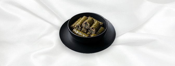Yaprak Sarma V N — Vine Leaves Stuffed With Rice, Onion, Parsley, Dried Currants, Pine Nuts And Herbs In A Lemon Juice And Ol