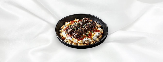 Yogurtlu Lamb Shish — Marinated Cubes Of Lamb Shish On A Bed Of Diced Bread With Yoghurt And Topped With Anatolian Sauce And