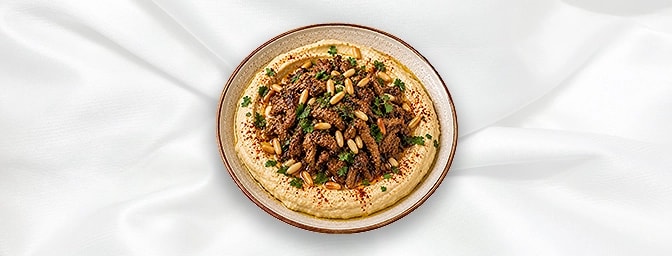 Hoummos Awarma N A — Hoummos topped with marinated lamb & pine nuts, GB Canteen Lebanese Barnes