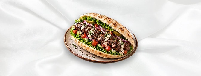 Lahim Meshou Sandwiches — Grilled skewers of tender lamb, often marinated with olive oil, garlic, lemon, and a mixture of spi