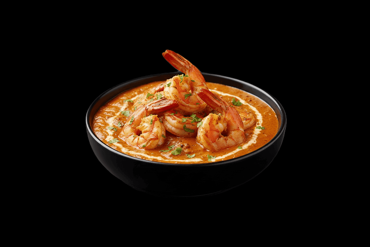 King Prawn Massala — King prawn grilled over charcoal cooked in mildly spiced oriental sauce with yoghurt, dressed with fresh