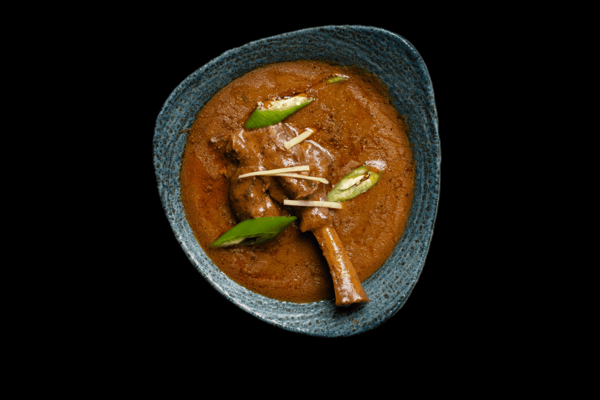 Lamb Shank — Traditional slow cooked Nepalese lamb shank served with a rich gravy of tomato, freshly ground spices, yoghurt a