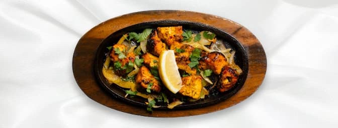 Chilli Chicken — Tender chicken cubes, cooked with a green chilli sauce, mixed peppers & flavoured with curry leaves and cori