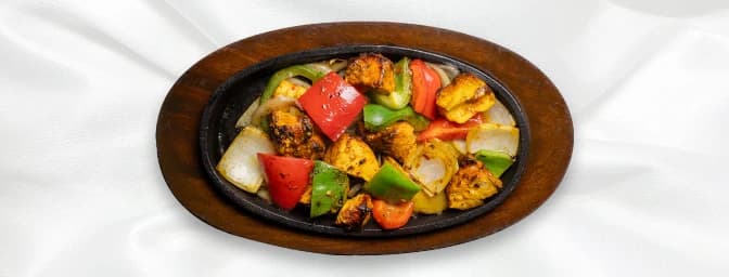 Chilli Paneer — Batons of cottage cheese, spiced with sweet and sour sauce and tossed with fresh tomatoes. This is a spicy, h