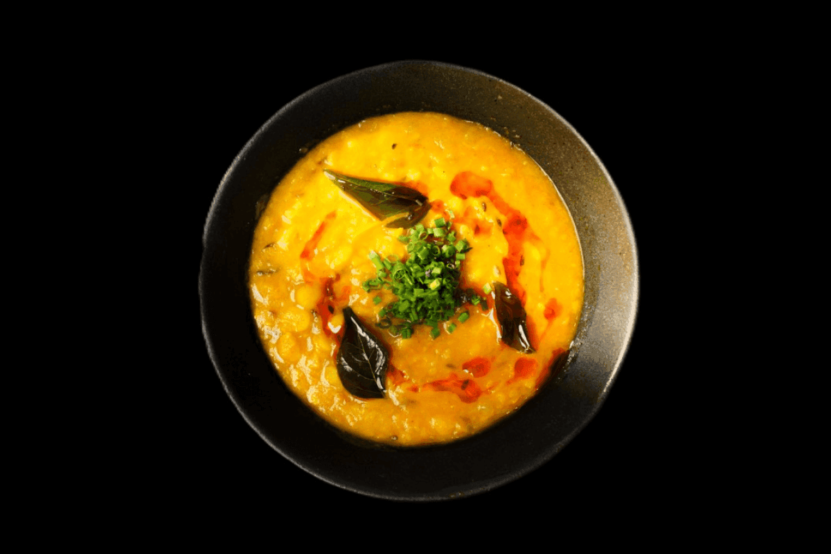 Daal Tarka — A comforting dish made from lentils cooked with spices and topped with a tempering of garlic, cumin, and other a