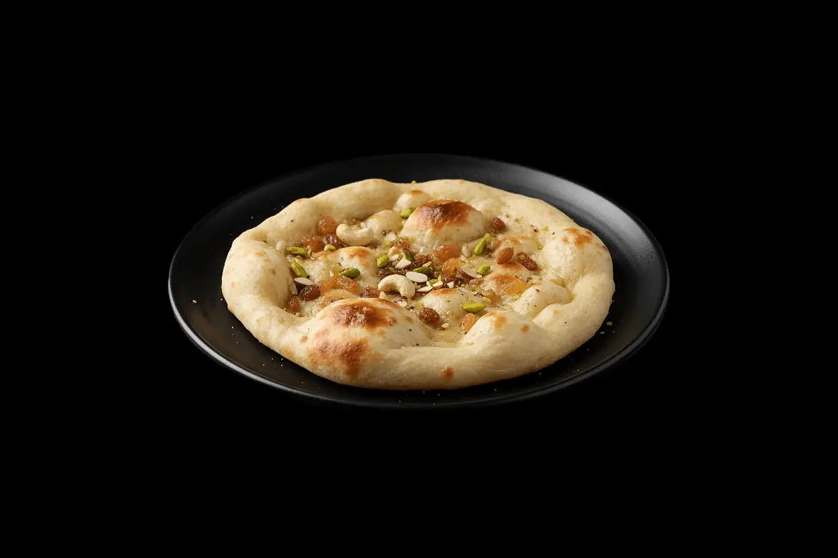 Peshwari Nan — A sweet variation of naan, filled with coconut, raisins, and almonds. Its a delicious complement to savory dis